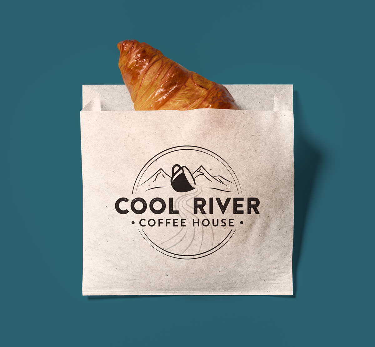croissant in a bag with Cool River Coffee House's logo