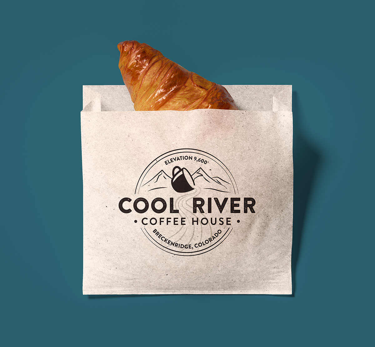 croissant in a bag with Cool River Coffee House's logo