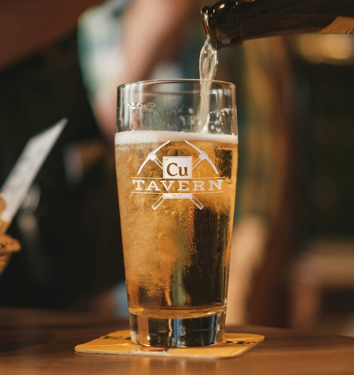 Cu Tavern logo on a beer glass